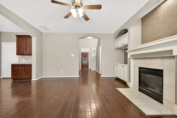 a kitchen with stainless steel appliances granite countertop a refrigerator a sink dishwasher a stove and a refrigerator with wooden floor