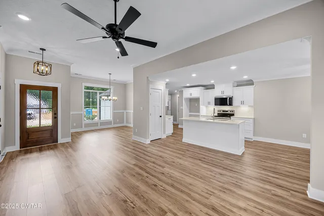 a view of kitchen with cabinets a fireplace and wooden floor