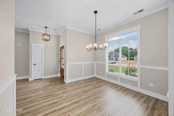a view of kitchen with cabinets and wooden floor