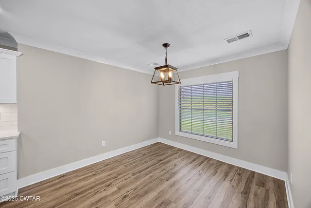 a kitchen with stainless steel appliances a sink stove and cabinets