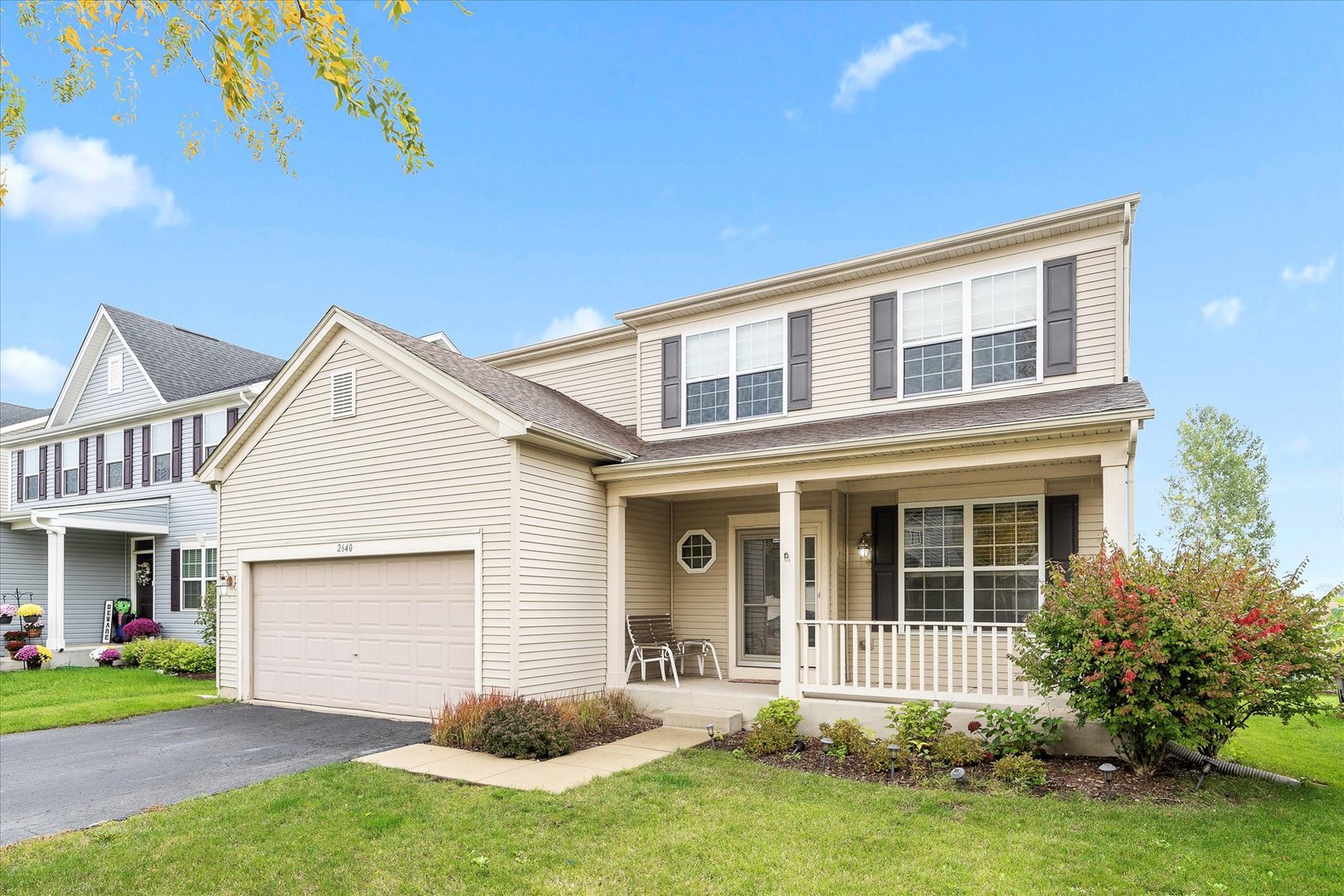 2640 Pecos Circle Montgomery, IL 60538 - Photo 2 of 31 a front view of a house with a yard and porch