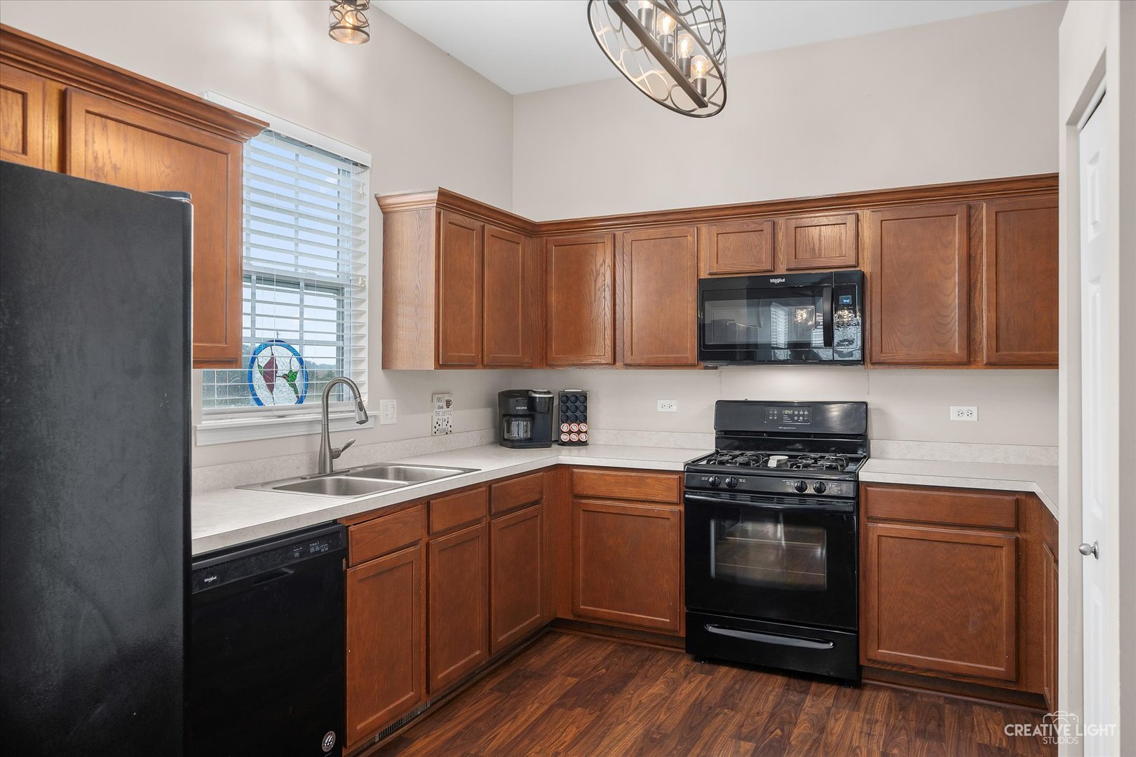 2640 Pecos Circle Montgomery, IL 60538 - Photo 10 of 31 a kitchen with stainless steel appliances a sink a stove a microwave and cabinets