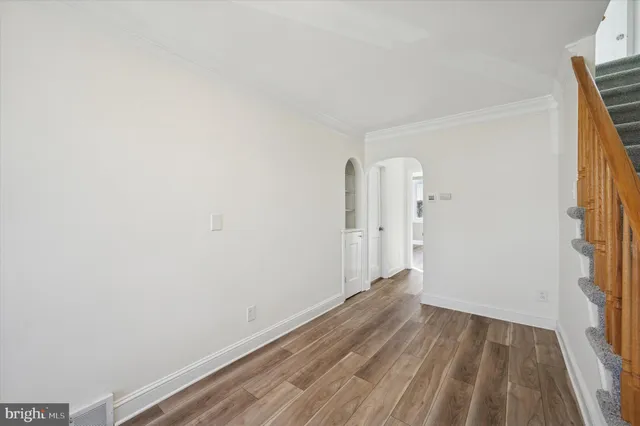 a view of a room with wooden floor and a window