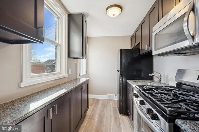 a kitchen with stainless steel appliances granite countertop a stove and a refrigerator