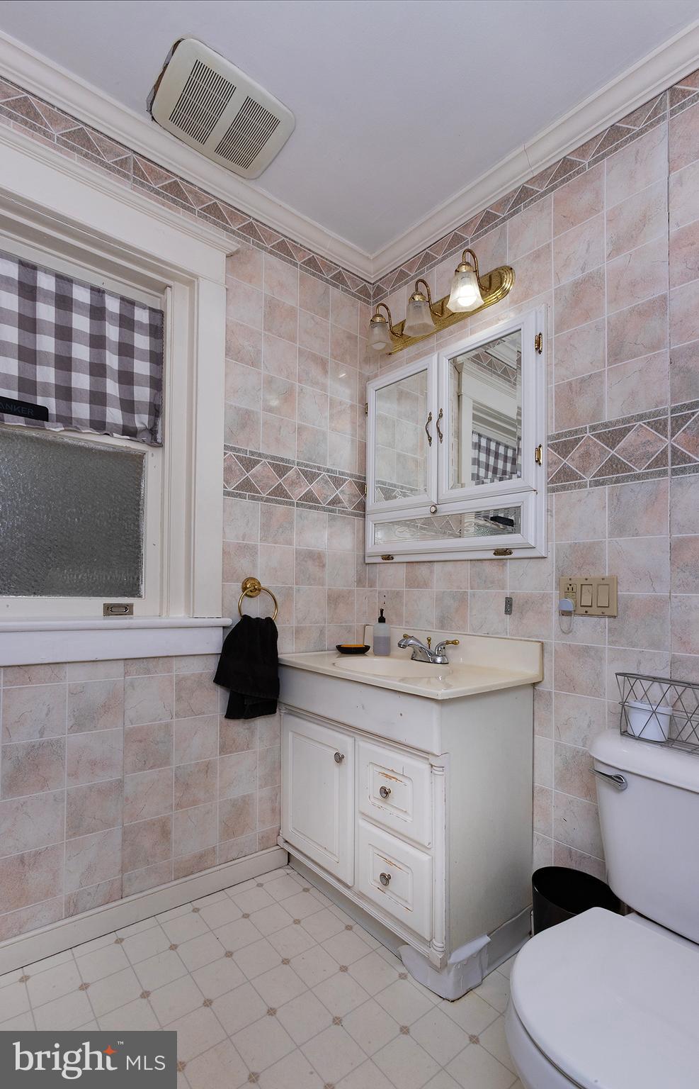 433 East Main Street, Unit B Palmyra, PA 17078 - Photo 16 of 35 a bathroom with a granite countertop toilet sink and mirror