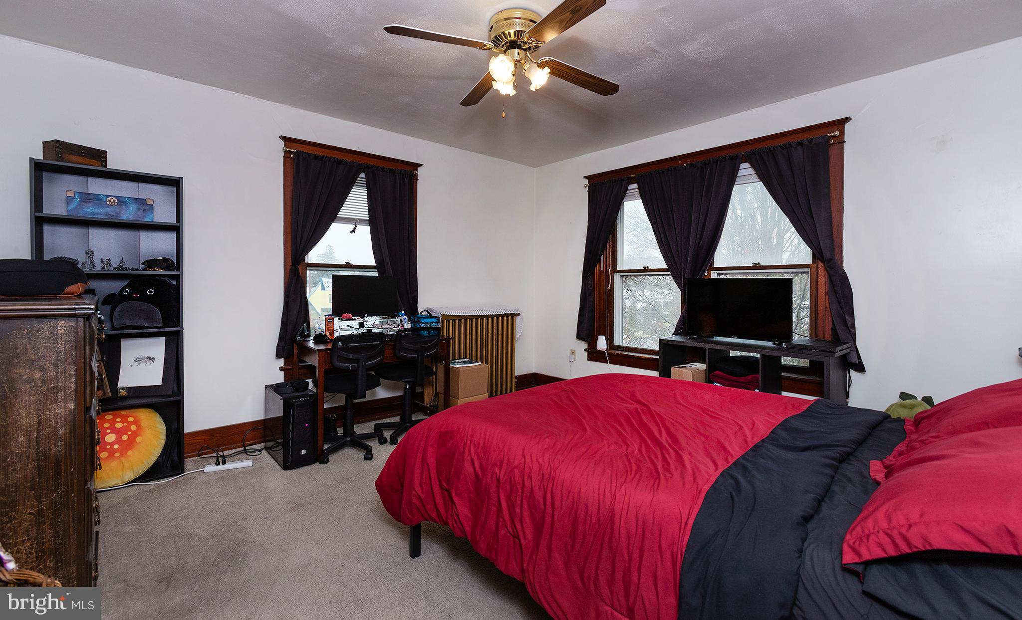 433 East Main Street, Unit B Palmyra, PA 17078 - Photo 24 of 35 a bedroom with a bed and a flat tv screen
