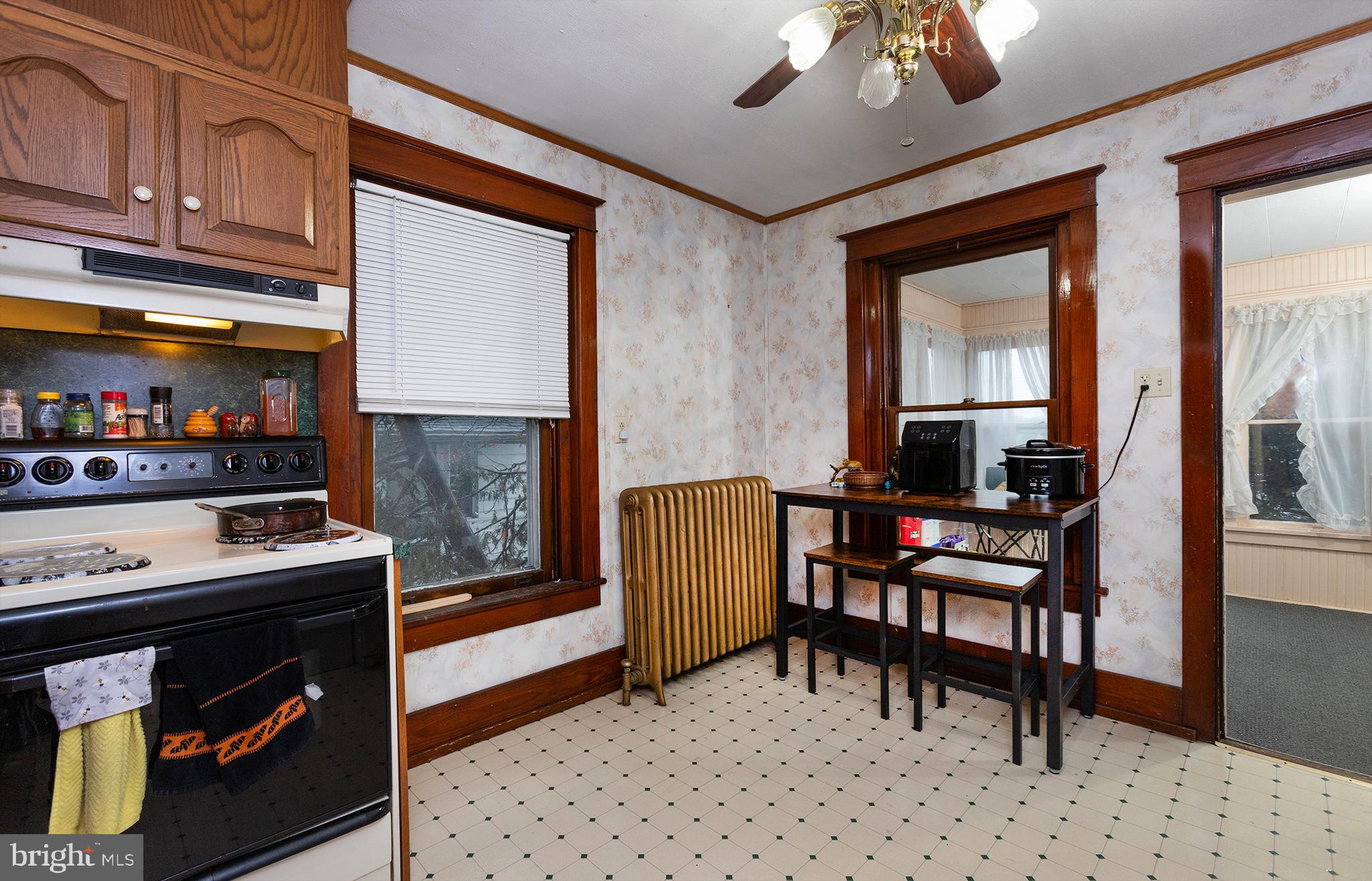 433 East Main Street, Unit B Palmyra, PA 17078 - Photo 8 of 35 a kitchen with stainless steel appliances granite countertop a stove a refrigerator a dining table and chairs with wooden floor