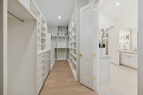 a spacious bathroom with a double vanity sink mirror and bathtub