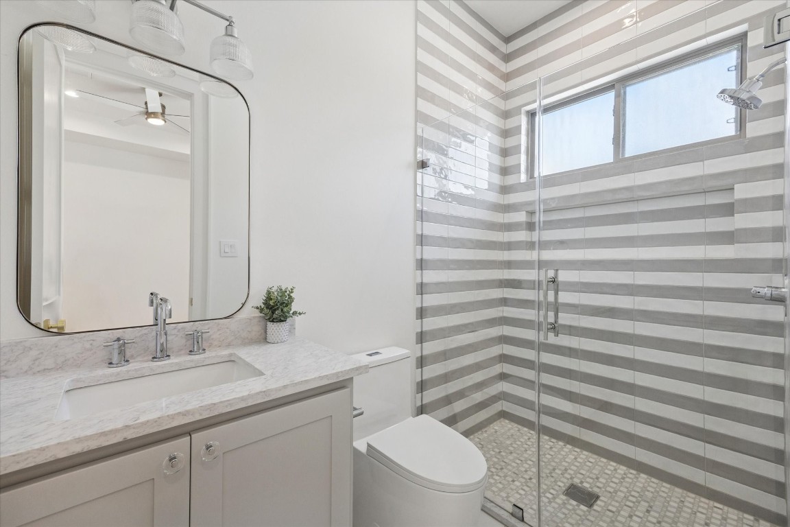 710 East 18th Street Houston, TX 77008 - Photo 29 of 41 a bathroom with a granite countertop sink toilet and shower
