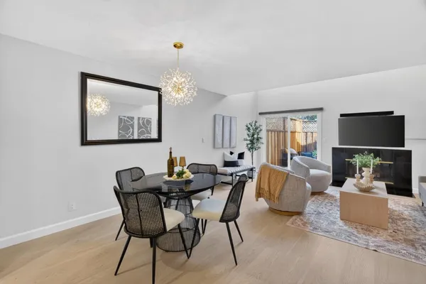 a view of a dining room with furniture and a chandelier