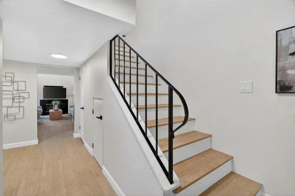 a view of entryway with wooden floor and stairs