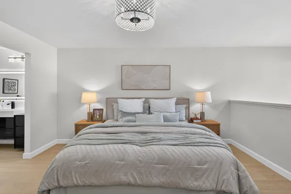 a bedroom with a bed and a chandelier