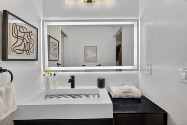 a bathroom with a sink and a mirror