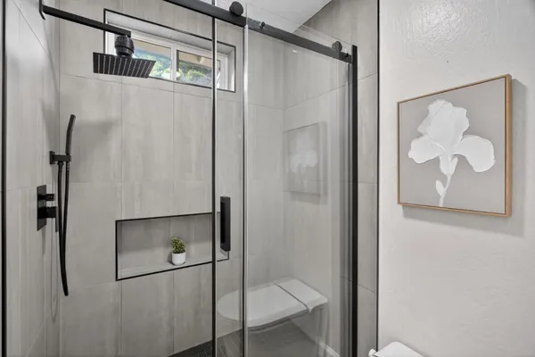 a bathroom with a glass shower door