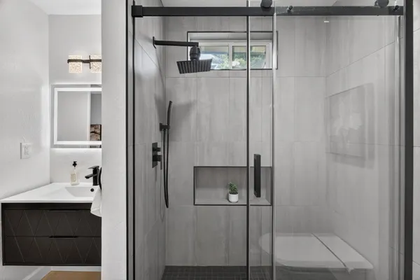 a bathroom with a shower and a sink