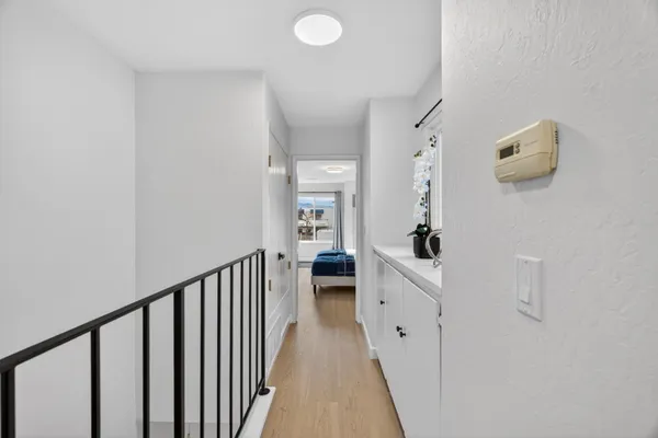a view of a hallway and a livingroom with furniture