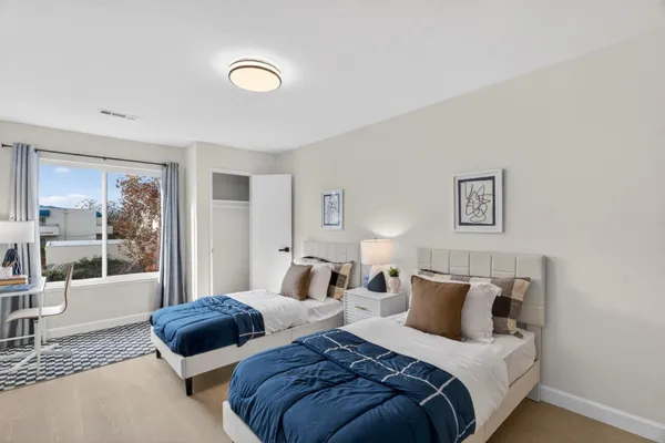 a bedroom with bed and a large window