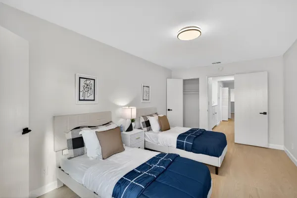 a bedroom with a bed and a lamp