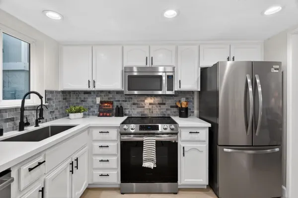 a kitchen with a refrigerator stove and sink