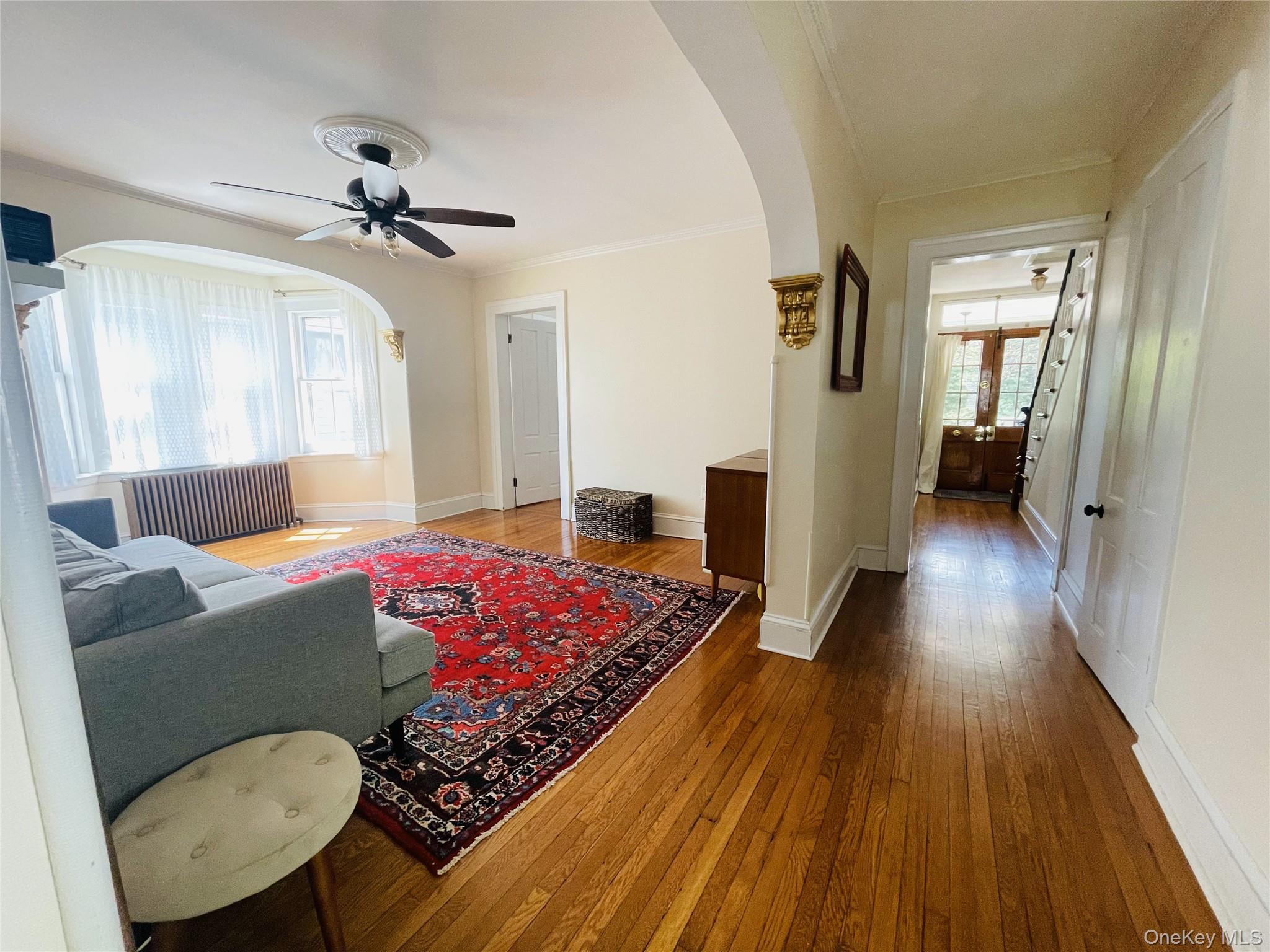 12 Parrott Street Cold Spring, NY 10516 - Photo 11 of 18 Living room with arched walkways, ceiling fan, and hardwood floors