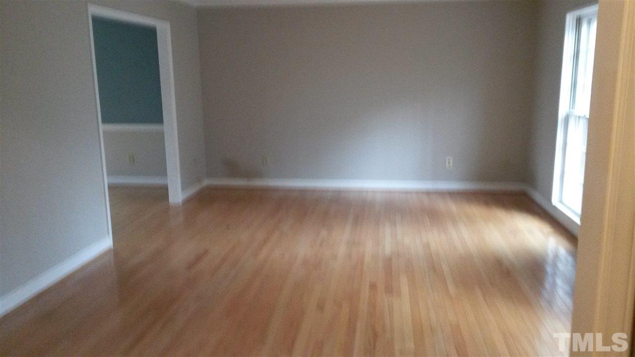 308 Dunstable Court Raleigh, NC 27614 - Photo 3 of 18 an empty room with wooden floor and windows