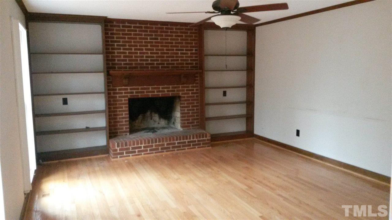 308 Dunstable Court Raleigh, NC 27614 - Photo 4 of 18 a view of empty room with a fireplace and wooden floor