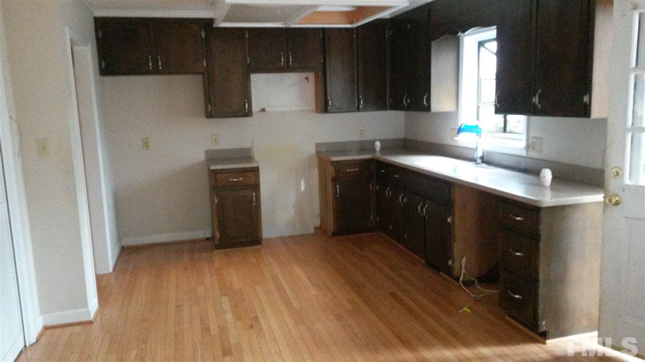 308 Dunstable Court Raleigh, NC 27614 - Photo 5 of 18 a kitchen with a wooden floor and cabinets