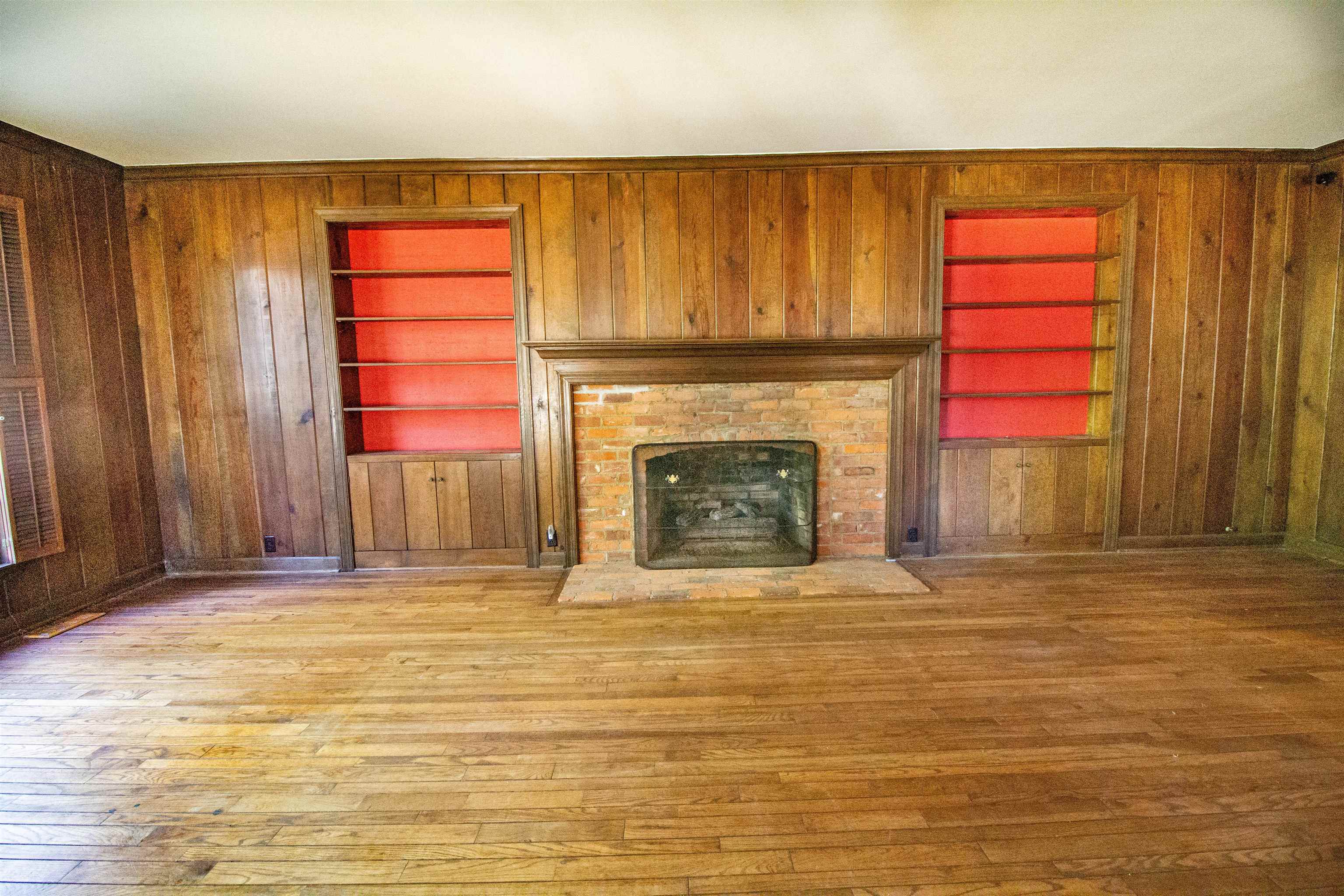283 Church Street Ripley, TN 38063 - Photo 16 of 36 a view of an empty room with a fireplace and a window