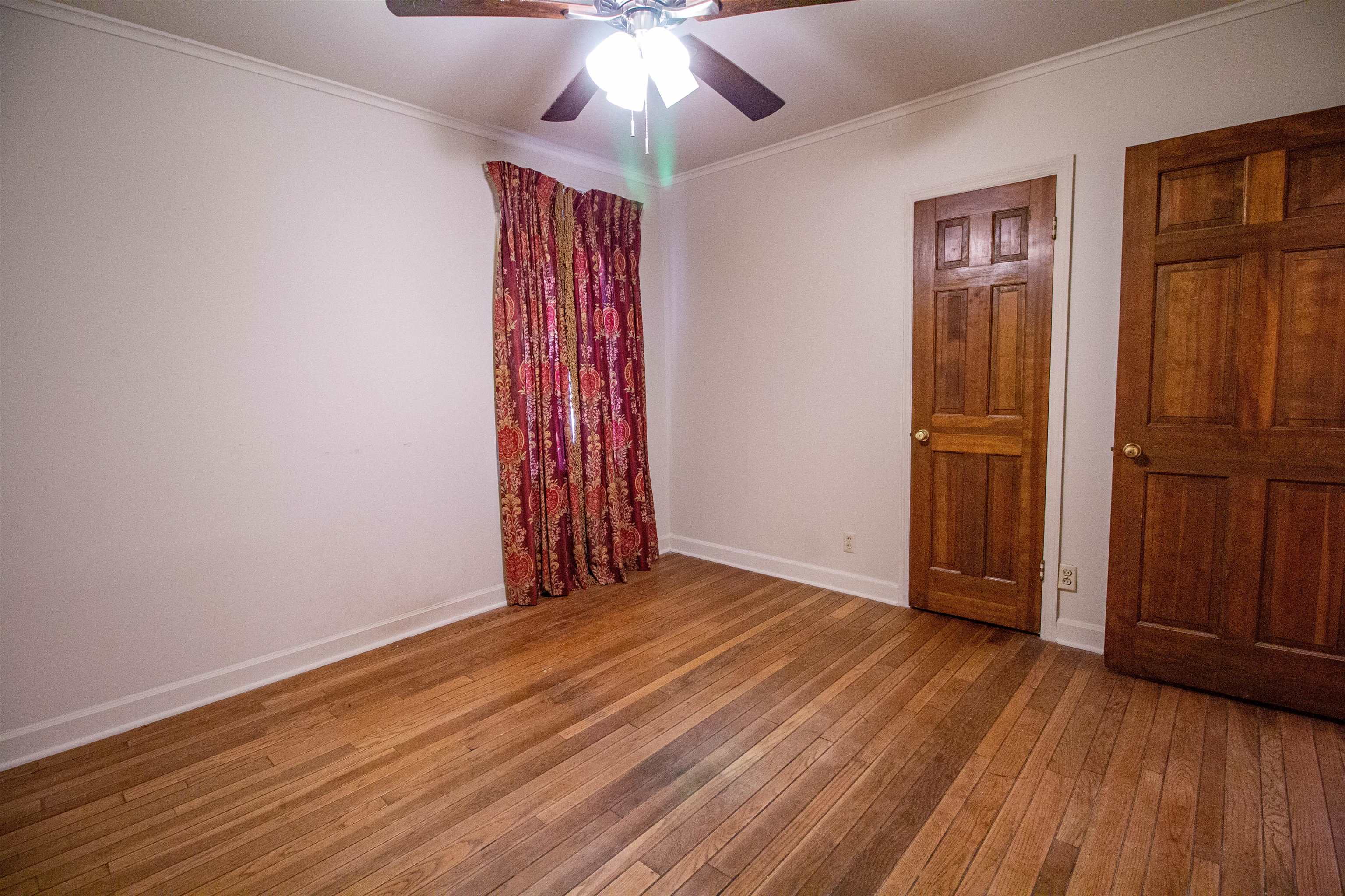 283 Church Street Ripley, TN 38063 - Photo 21 of 36 an empty room with wooden floor closet and windows