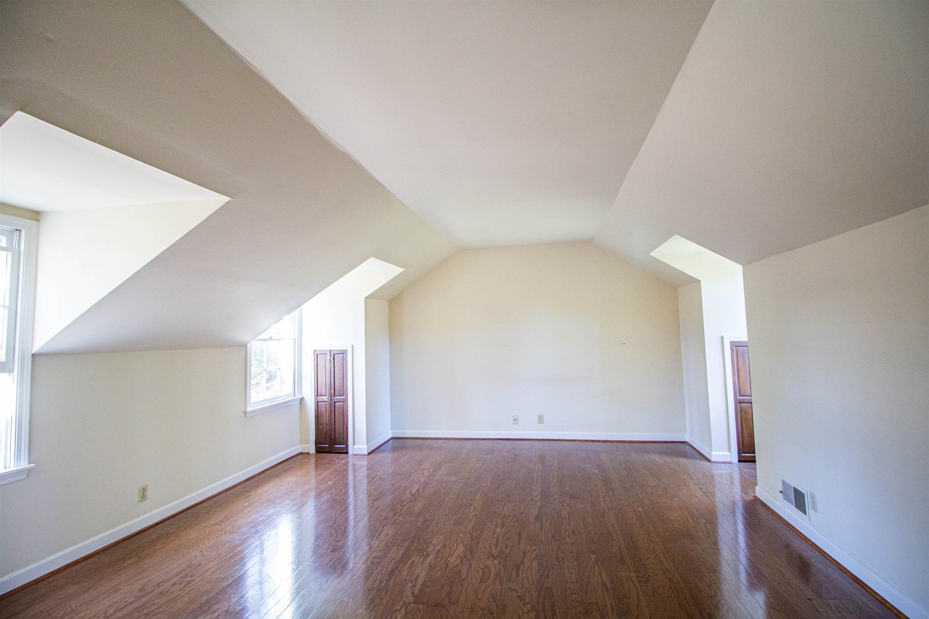 283 Church Street Ripley, TN 38063 - Photo 25 of 36 an empty room with wooden floor and windows