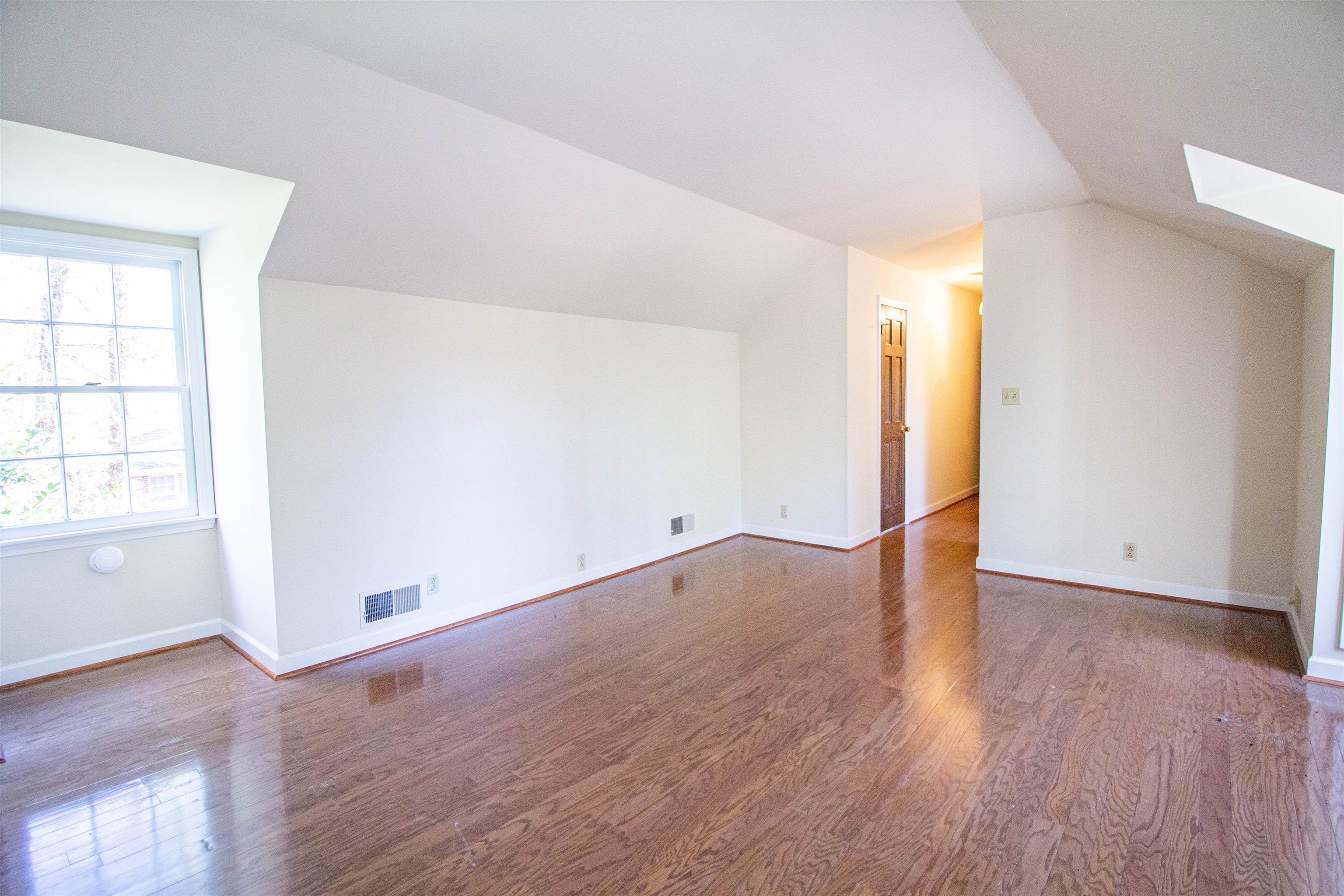 283 Church Street Ripley, TN 38063 - Photo 26 of 36 an empty room with wooden floor and windows