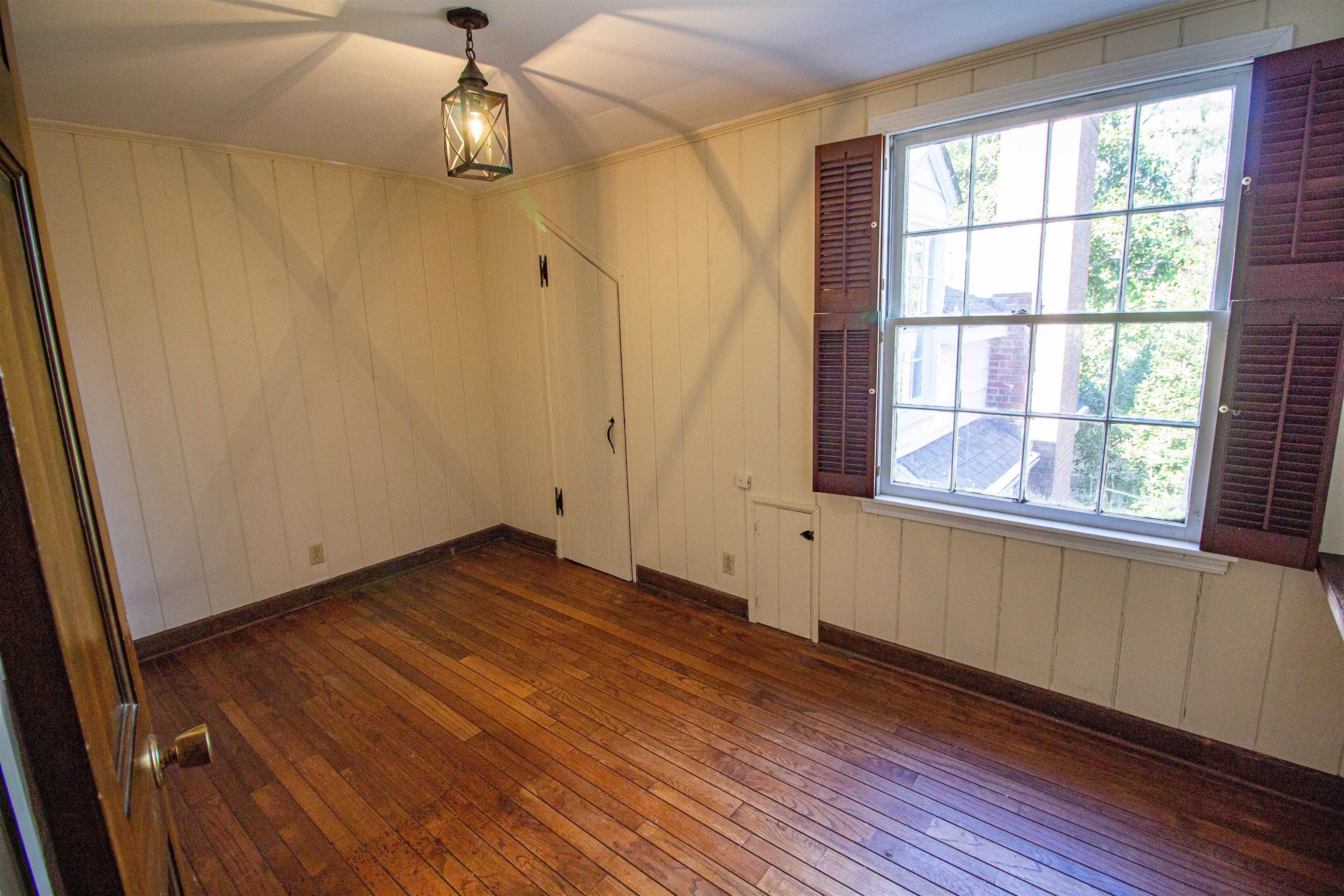 283 Church Street Ripley, TN 38063 - Photo 33 of 36 a view of an empty room with wooden floor and a window