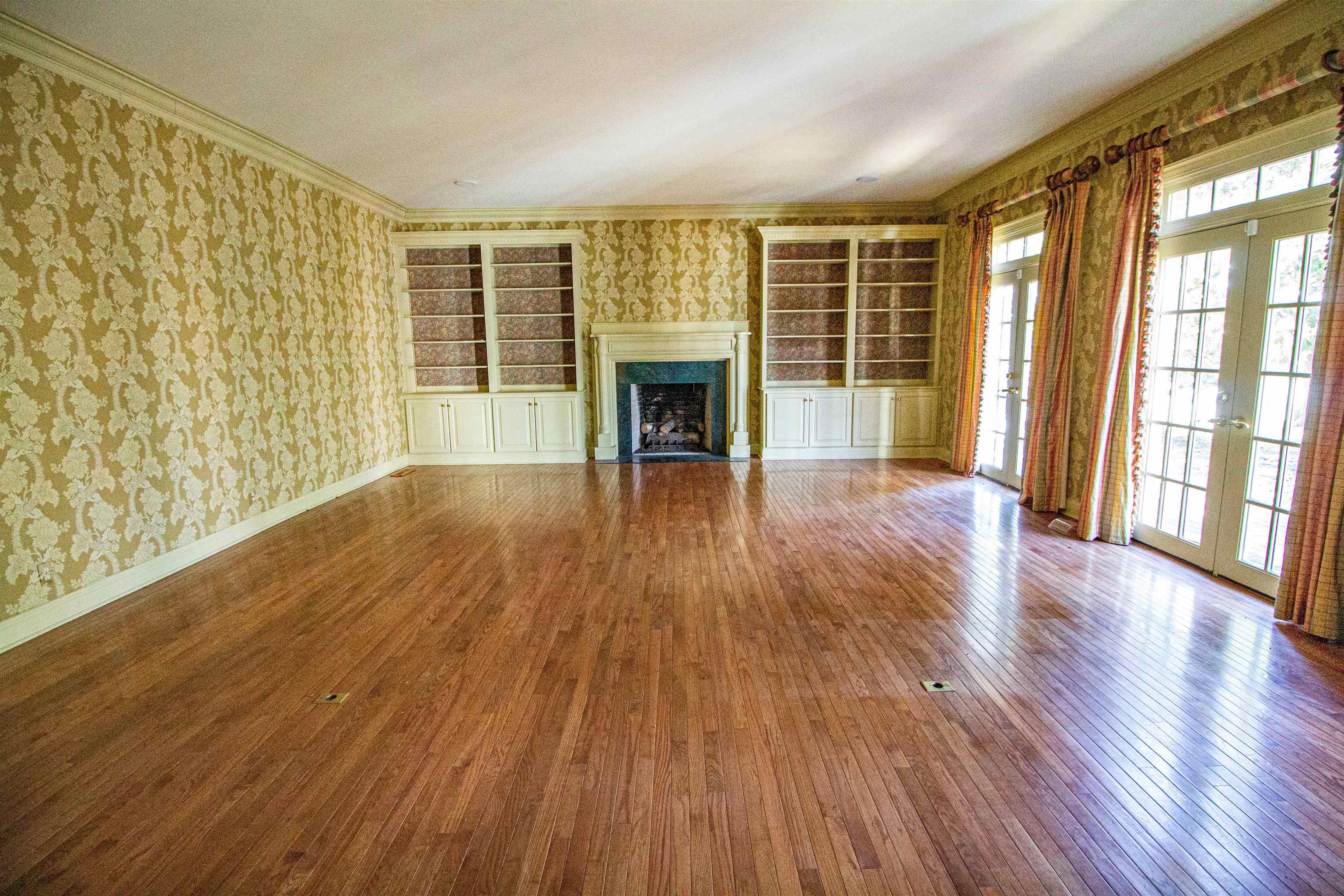 283 Church Street Ripley, TN 38063 - Photo 6 of 36 a view of an empty room with wooden floor and a window