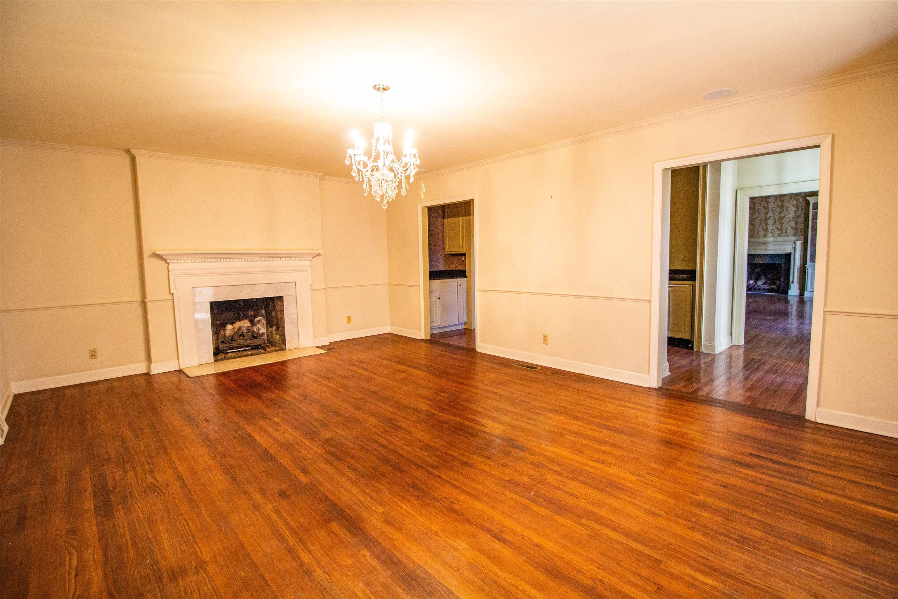 283 Church Street Ripley, TN 38063 - Photo 9 of 36 a view of empty room with wooden floor and fireplace