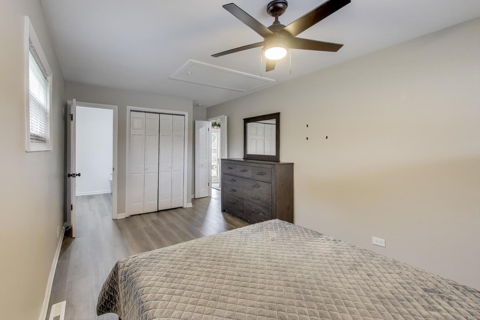 540 Newark Lane Hoffman Estates, IL 60169 - Photo 13 of 23 a bedroom with a bed and a chandelier
