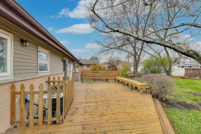a view of balcony with wooden floor and fence