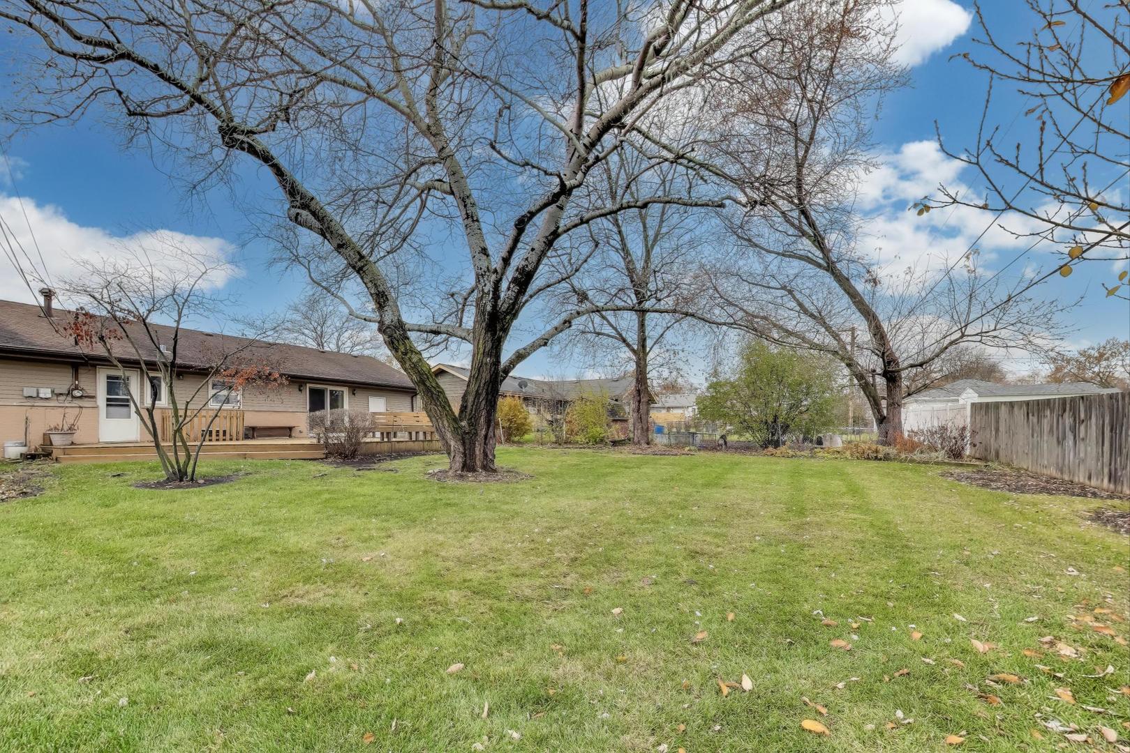 540 Newark Lane Hoffman Estates, IL 60169 - Photo 23 of 23 a view of a yard with a house and a large tree