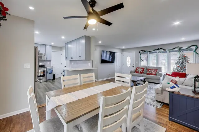 a dining room with kitchen island furniture and a chandelier