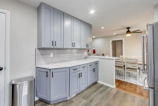 a kitchen with cabinets and window