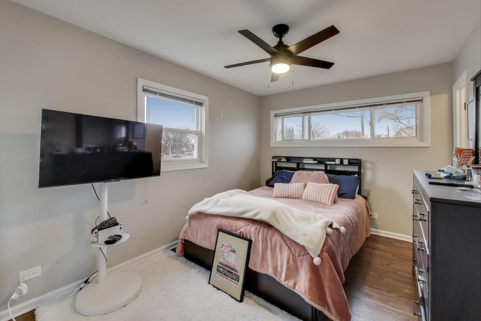 540 Newark Lane Hoffman Estates, IL 60169 - Photo 9 of 23 a bedroom with a bed a flat screen tv and guitar
