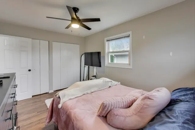 a bedroom with a bed and a chandelier