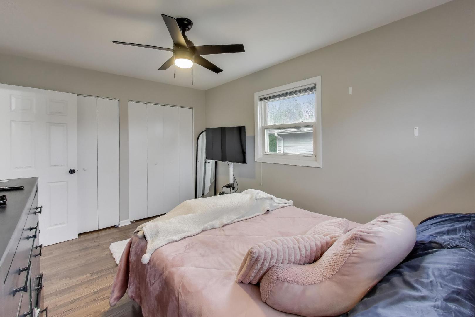 540 Newark Lane Hoffman Estates, IL 60169 - Photo 10 of 23 a bedroom with a bed and a chandelier