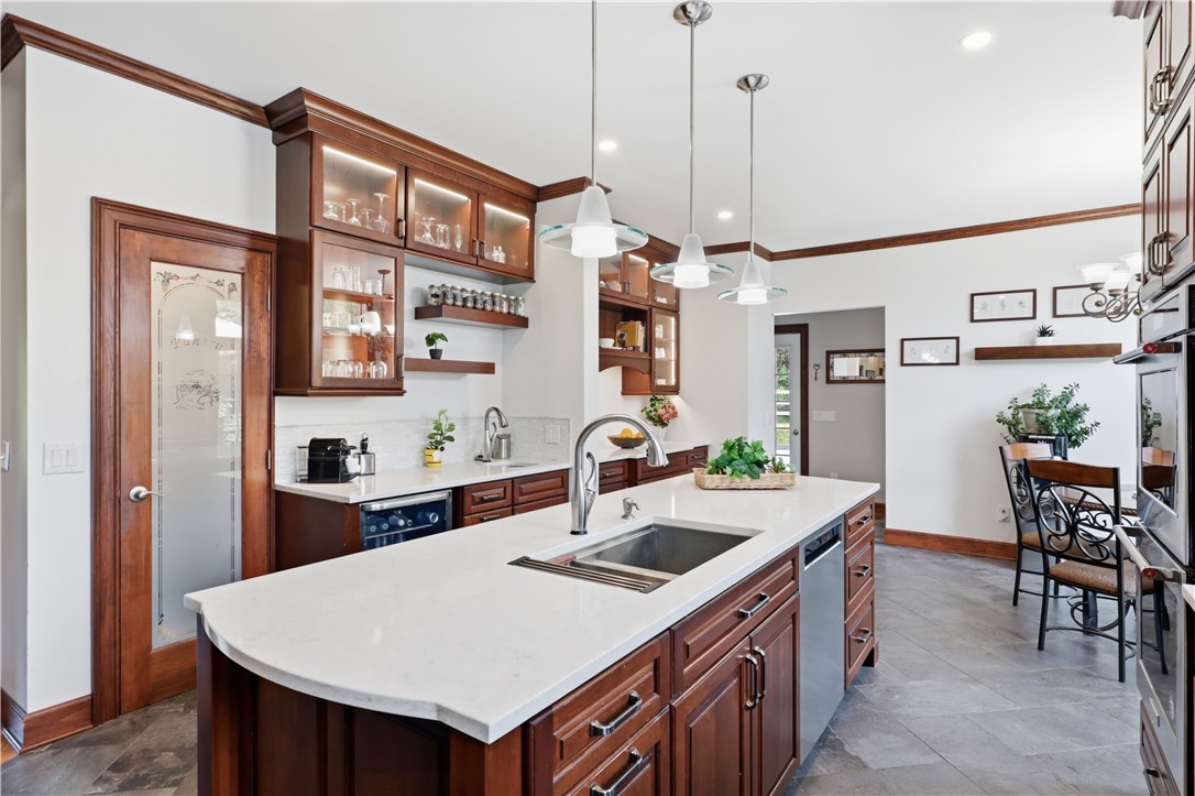 2057 Stirnie Road Victor, NY 14564 - Photo 11 of 48 Another angle of the kitchen highlights the bright workspace and functional layout. Tucked conveniently off the main cooking area is a generous walk-in pantry closet providing exceptional storage solutions.