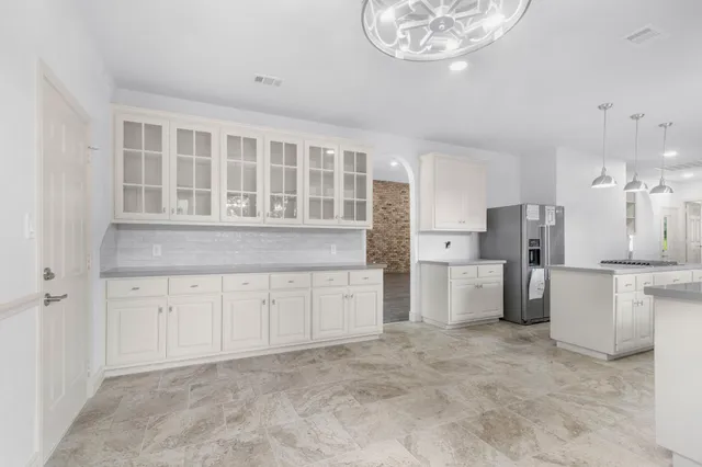 a kitchen with white cabinets and a sink