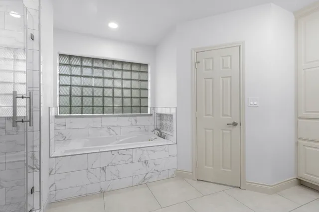 a bathroom with a bathtub and shower