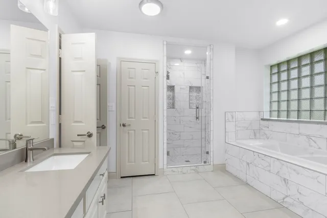 a spacious bathroom with a shower tub double and sink