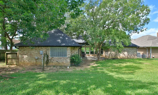a backyard of a house with table and chairs