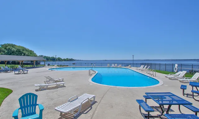 a view of a swimming pool with lounge chairs