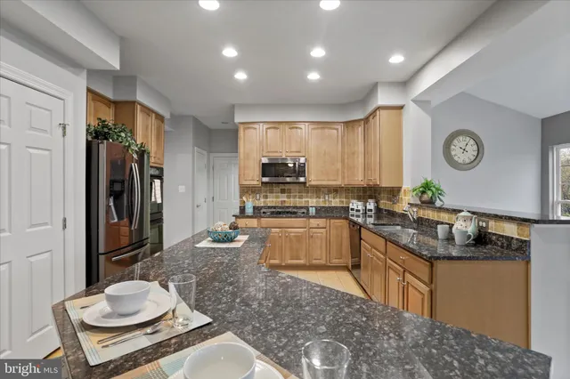 a large kitchen with a large window and stainless steel appliances