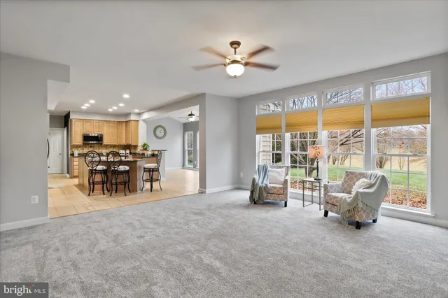 a view of a livingroom with furniture and a large window